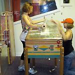 Volunteers wrap a pinball game at the National Pinball Museum.