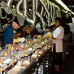 Soldering wire harnesses onto Taxi playfields at the Williams Pinball Factory