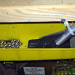 Wedge shaped pressure switch in upper tray controls the ball lifter motor.